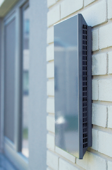 AIRUNIT exterior ventilation grille installed beside a residential window